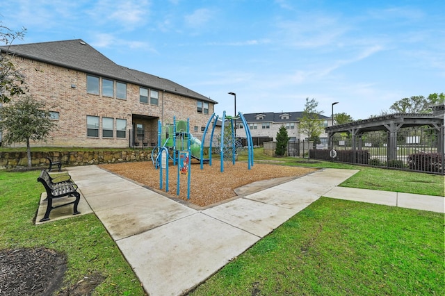 view of playground with a yard and a pergola