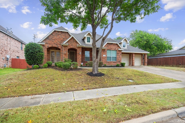 view of front of home with a garage and a front yard