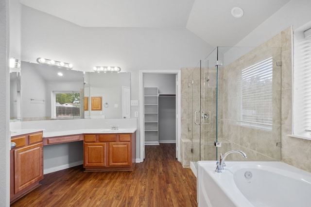 bathroom featuring shower with separate bathtub, lofted ceiling, hardwood / wood-style flooring, and vanity