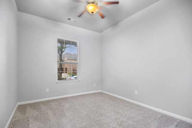 carpeted spare room featuring ceiling fan