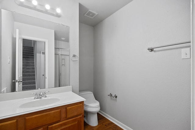 bathroom with hardwood / wood-style flooring, vanity, and toilet