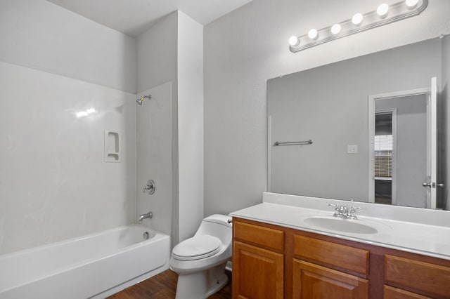 full bathroom featuring vanity, hardwood / wood-style flooring, toilet, and  shower combination