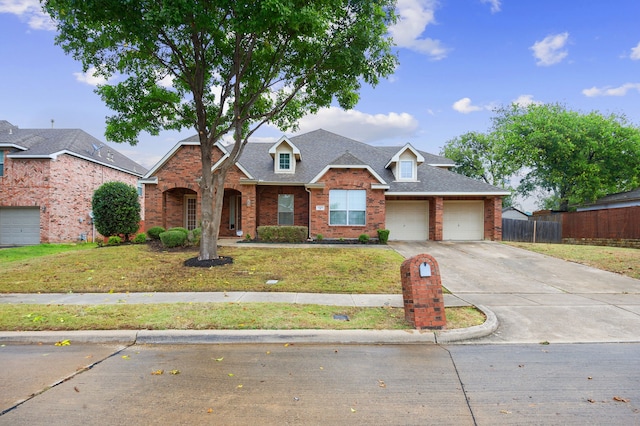 view of front of home with a garage and a front lawn