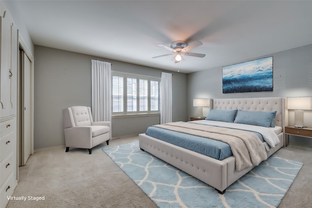 bedroom with ceiling fan and light carpet