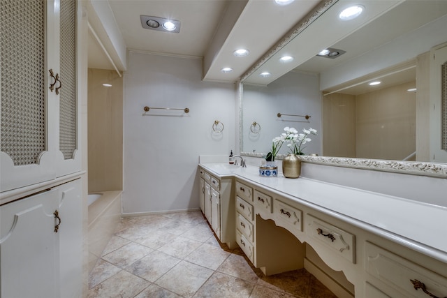 bathroom with vanity, a tub, and tile patterned flooring