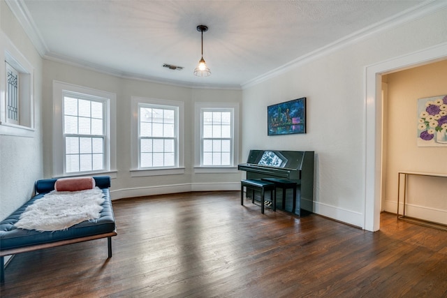 living area with baseboards, visible vents, dark wood finished floors, and ornamental molding