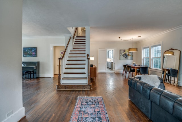 living area with baseboards, stairs, ornamental molding, and dark wood-style flooring