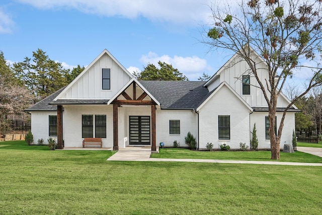 modern inspired farmhouse with a front lawn