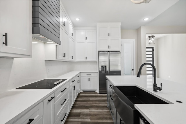 kitchen featuring white cabinetry, black electric stovetop, dark wood-type flooring, and premium range hood