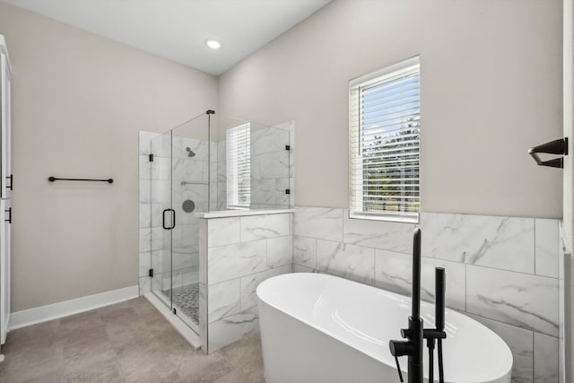 bathroom featuring independent shower and bath