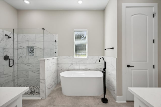 bathroom featuring tile walls, vanity, tile patterned flooring, and separate shower and tub