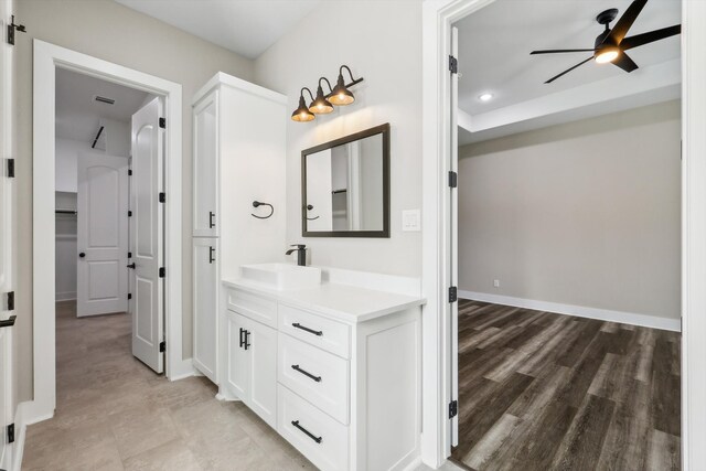 bathroom featuring hardwood / wood-style floors, ceiling fan, and vanity