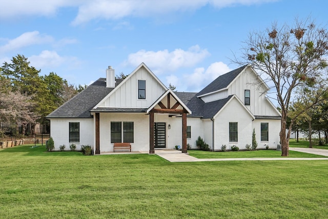 modern inspired farmhouse with a front lawn