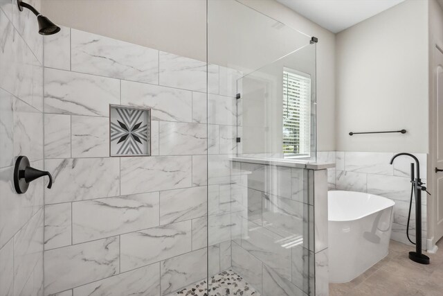 bathroom with independent shower and bath and tile walls