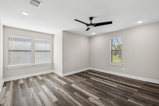 empty room with dark hardwood / wood-style floors and ceiling fan