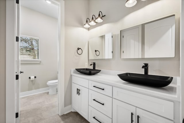 bathroom with toilet and vanity