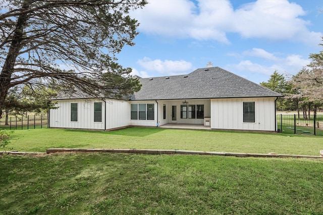 back of property with a patio and a yard