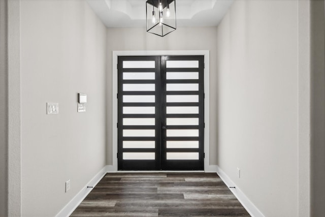 entrance foyer featuring french doors, dark hardwood / wood-style flooring, and a chandelier