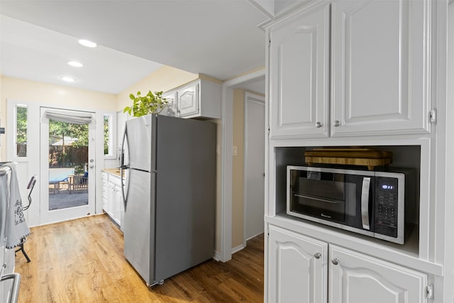 kitchen featuring light hardwood / wood-style flooring, white cabinets, and stainless steel appliances