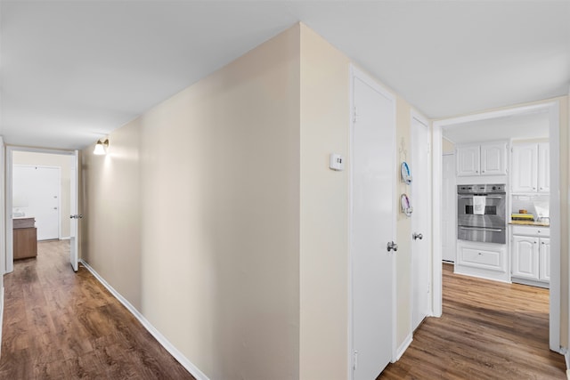 corridor featuring dark hardwood / wood-style floors