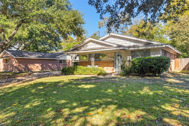 view of front of home featuring covered porch and a front yard