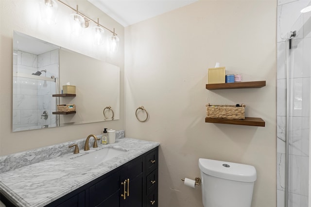 bathroom featuring vanity, toilet, and a shower with shower door