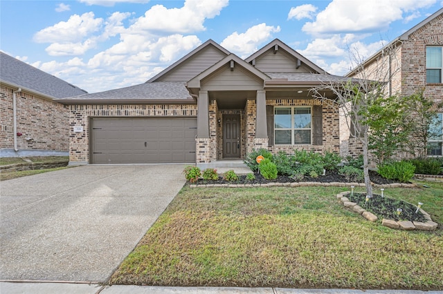 craftsman house with a garage and a front lawn