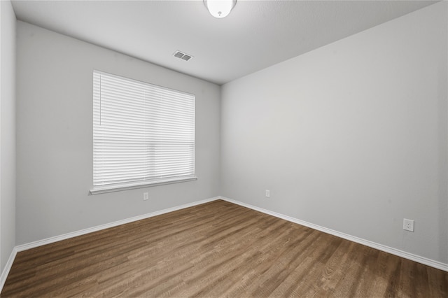 empty room with hardwood / wood-style flooring