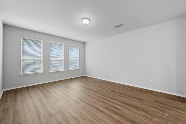 spare room with hardwood / wood-style flooring