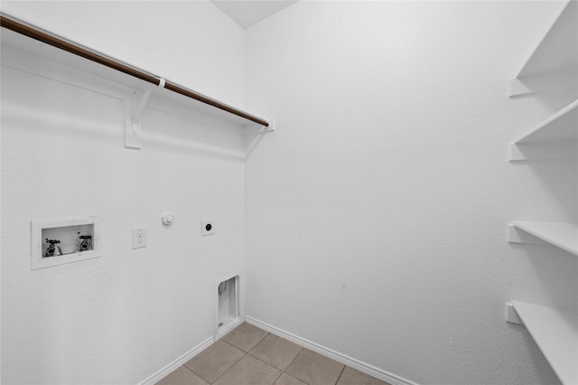 clothes washing area featuring gas dryer hookup, washer hookup, light tile patterned floors, and electric dryer hookup