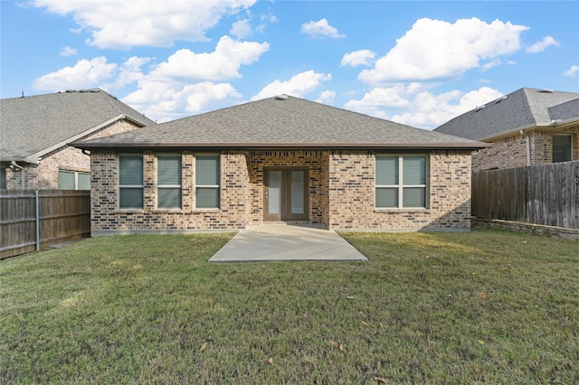 rear view of house with a patio area and a yard