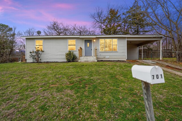 view of front of house with a front lawn and a carport