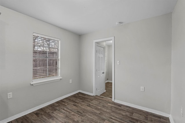 unfurnished room with dark hardwood / wood-style floors