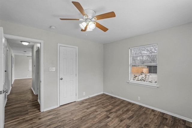 unfurnished bedroom with dark wood-type flooring, a closet, and ceiling fan