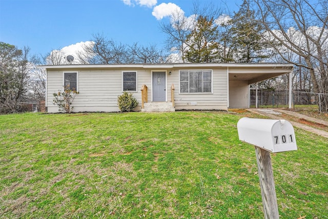 single story home with a front lawn and a carport