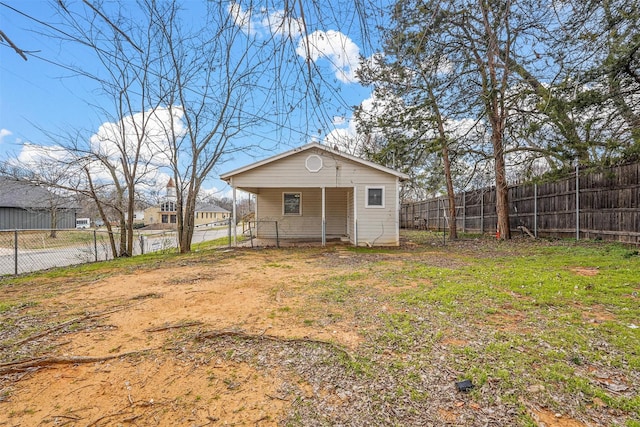 rear view of house featuring a yard