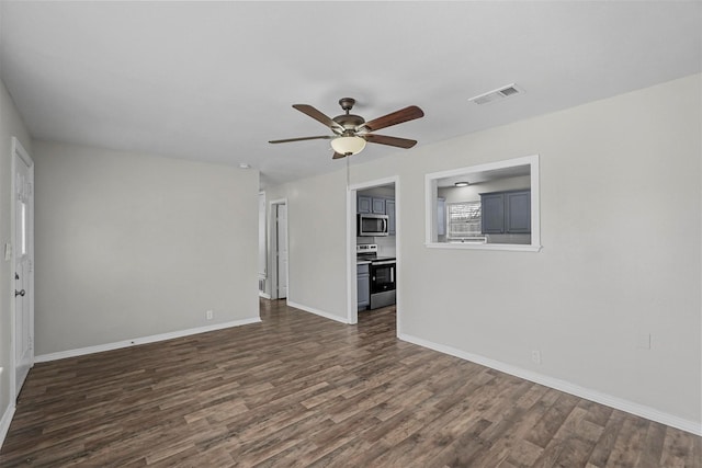 unfurnished living room featuring dark wood-type flooring and ceiling fan