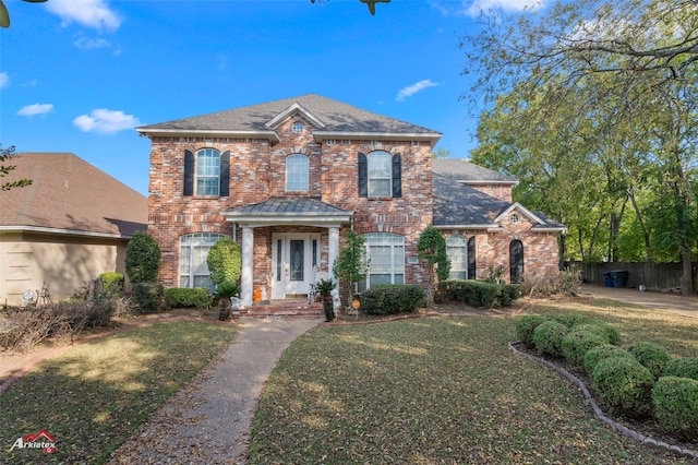 colonial inspired home with a front lawn