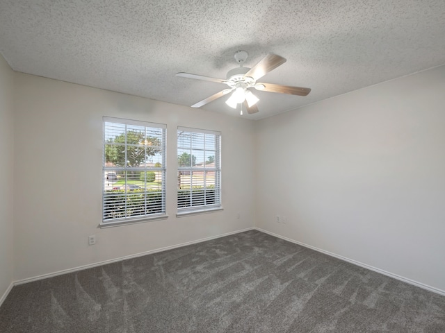 unfurnished room featuring a textured ceiling, ceiling fan, and dark carpet