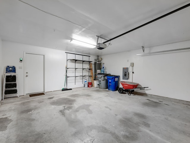 garage featuring electric panel, a garage door opener, and gas water heater