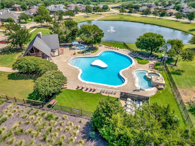 view of pool with a community hot tub, a water view, a lawn, and a patio