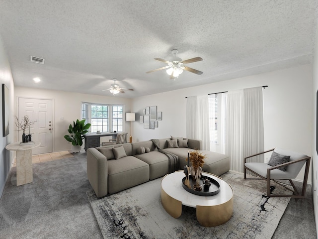 living room featuring carpet, a textured ceiling, and ceiling fan