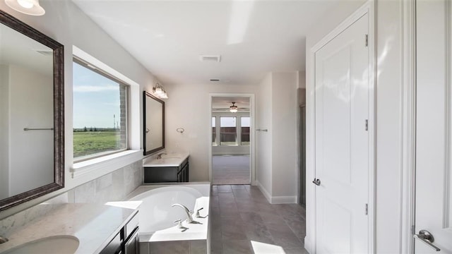 bathroom featuring vanity, ceiling fan, a relaxing tiled tub, and wood-type flooring