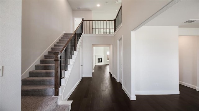 foyer featuring a high ceiling and dark hardwood / wood-style floors