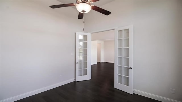 spare room with dark wood-type flooring, ceiling fan, and french doors