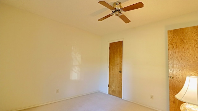 unfurnished room with ceiling fan and carpet floors