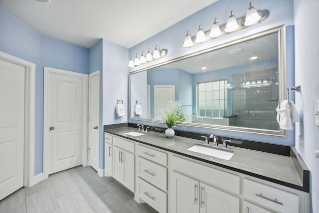 bathroom featuring vanity and a shower with shower door