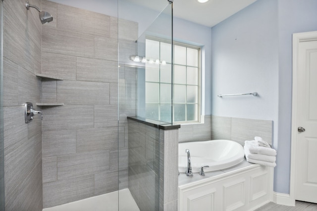 bathroom featuring a wealth of natural light and independent shower and bath