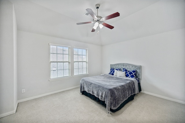 bedroom featuring ceiling fan, light colored carpet, and vaulted ceiling