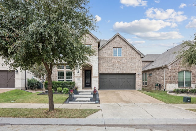 view of front of home with a front yard and a garage